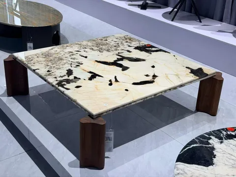 cream-beige stone coffee table, with cloudy mottling, in a showroom