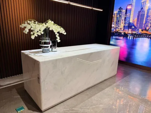 white stone countertop, with a waterfall edge and fine veining, in a showroom