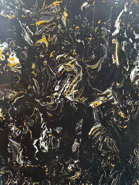 black engineered stone slab, with a single full slab and bold veining, in a close surface view