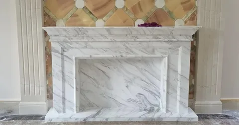 travertine fireplace surround, with fine veining and a reflective finish, in a furnished room
