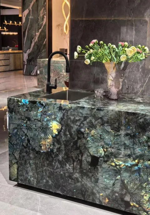 green stone countertop, with a crystalline texture and a reflective finish, in a showroom