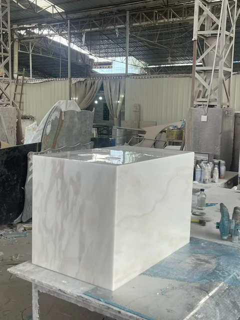 white stone vanity, with an integrated basin and cloudy mottling, in a workshop