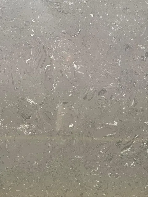 gray engineered stone slab, with cloudy mottling and subtle pattern contrast and an uncluttered setting
