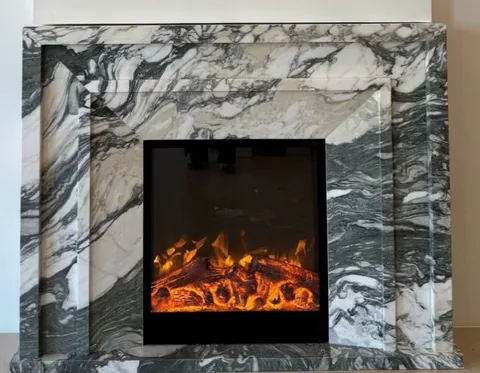 White Volakas marble fireplace surround, with broad sweeping markings