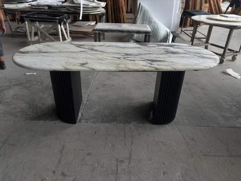 white stone dining table, with workshop equipment nearby