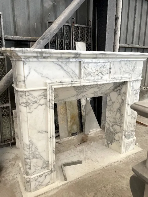 White Volakas marble fireplace surround, with fine veining, shown from an angled view with broad sweeping markings