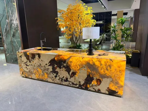 gold stone countertop, with a single-level island and cloudy mottling, in a showroom