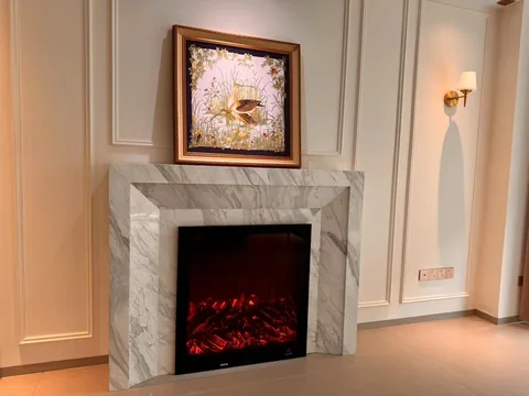 White Volakas marble fireplace surround, showing a single main form with broad sweeping markings