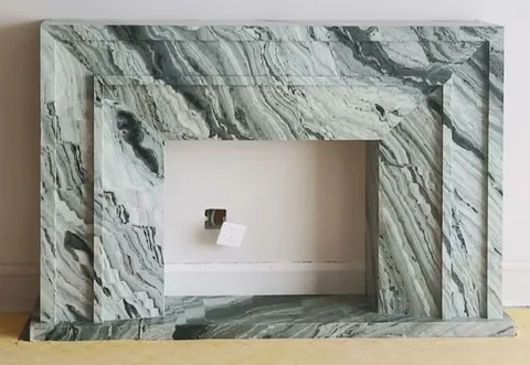 White Volakas marble fireplace surround, with bold veining, shown from a frontal view