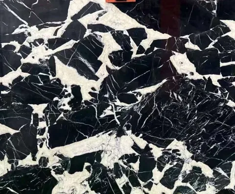 black stone slab, with a single full slab and angular breccia fragments, in a close surface view