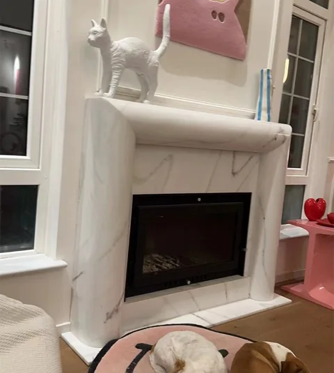 travertine fireplace surround, with fine veining, in a furnished room