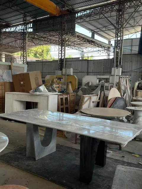 white stone dining table, with fine veining, shown from an angled view