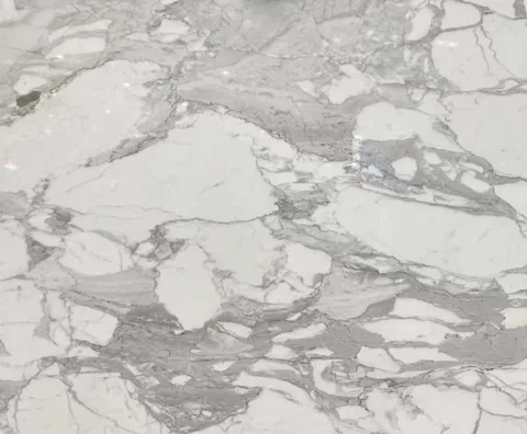 white stone slab, showing a single main form with broad sweeping markings