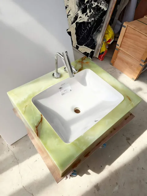green stone vanity, with cloudy mottling and a reflective finish, in a workshop