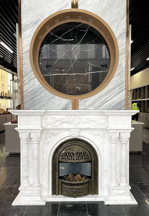 White Volakas marble fireplace surround, with an arched opening and fine veining, in a showroom