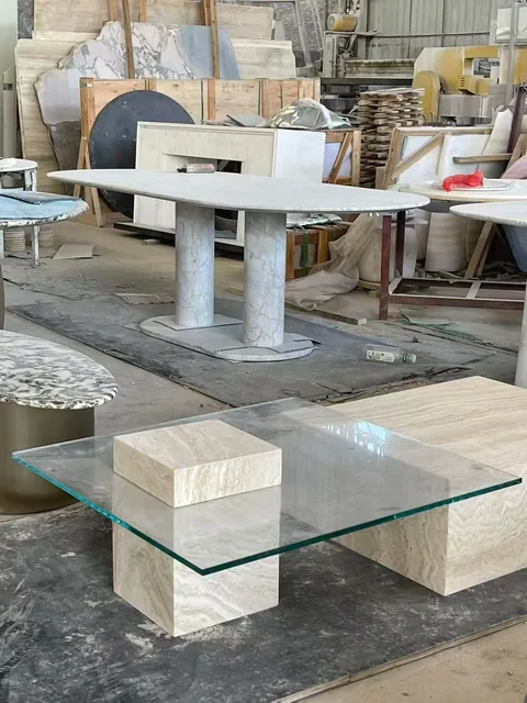 cream-beige stone coffee table, with fine veining, in a workshop