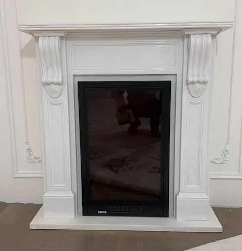 travertine fireplace surround, with a plain surface and a reflective finish, against a pale background