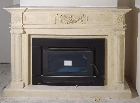 White Volakas marble fireplace surround, with a plain surface, against a pale background