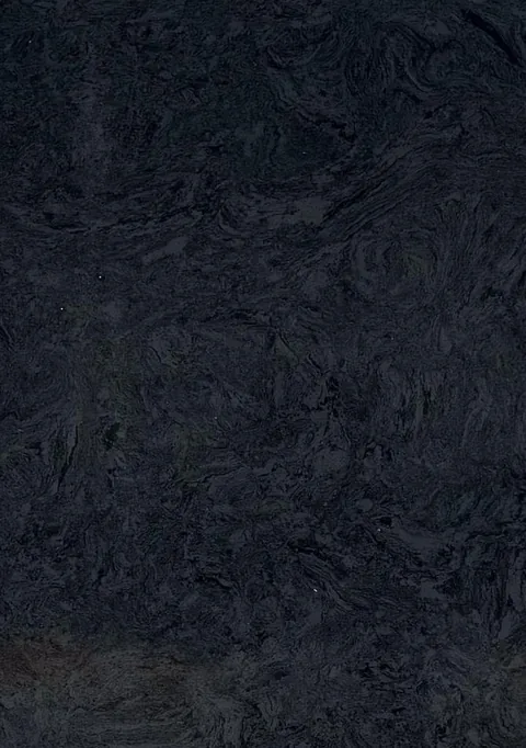 black engineered stone slab, with a single full slab and cloudy mottling, in a close surface view