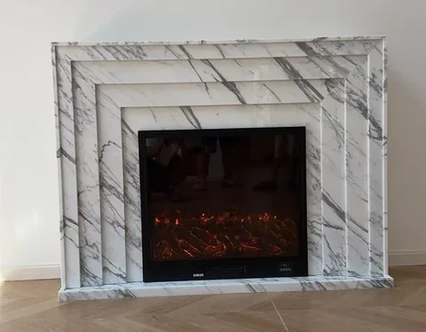 Arabescato Corchia marble fireplace surround, with bold veining, shown from a frontal view
