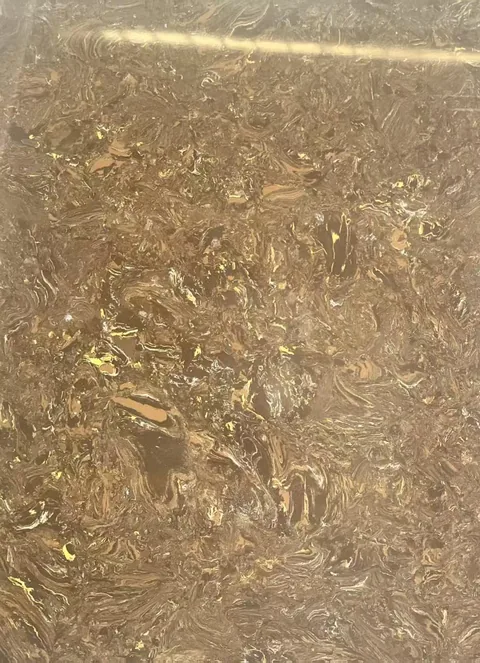 brown engineered stone slab, with a single full slab and cloudy mottling, in a close surface view