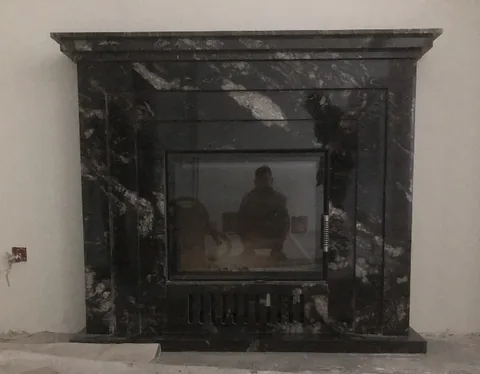 White Volakas marble fireplace surround, with bold veining and broad sweeping markings