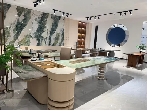 white stone dining table, with twin supporting bases and bold veining, in a showroom
