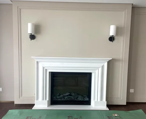 travertine fireplace surround, with stepped tiers and a plain surface, in a furnished room
