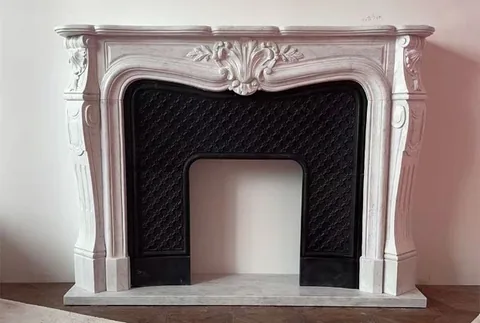 White Volakas marble fireplace surround, with fine veining, on a plain backdrop
