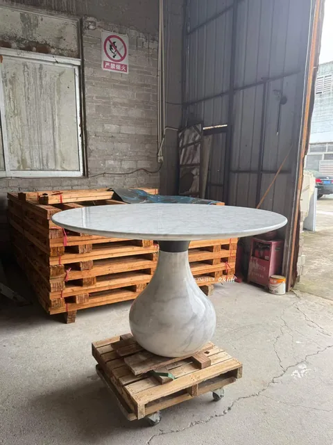white stone dining table, shown from an angled view with single main form