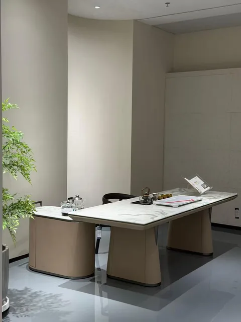 white stone desk, with twin supporting bases and fine veining, in a showroom