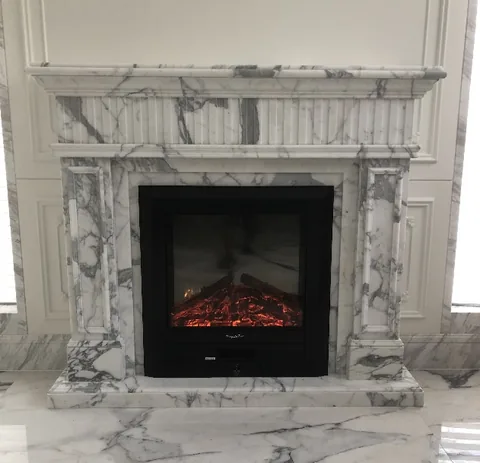 Arabescato Corchia marble fireplace surround, with bold veining and strong pattern contrast