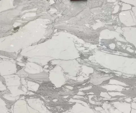 white stone slab, with broad sweeping markings and an uncluttered setting