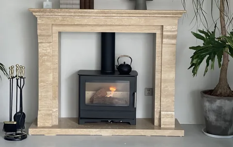travertine fireplace surround, with linear travertine grain, in a furnished room