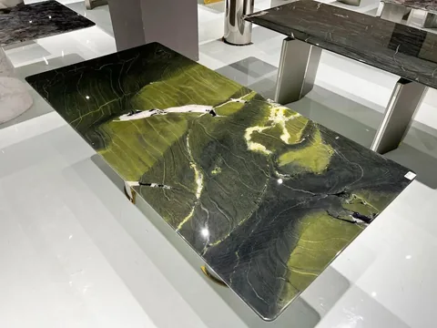 green stone coffee table, with a rectangular top and bold veining, in a showroom