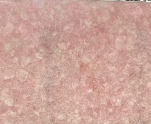 rose-red stone slab, with a single full slab and angular breccia fragments, in a close surface view