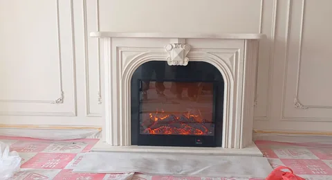 White Volakas marble fireplace surround, with plain surface, shown from a frontal view with single main form
