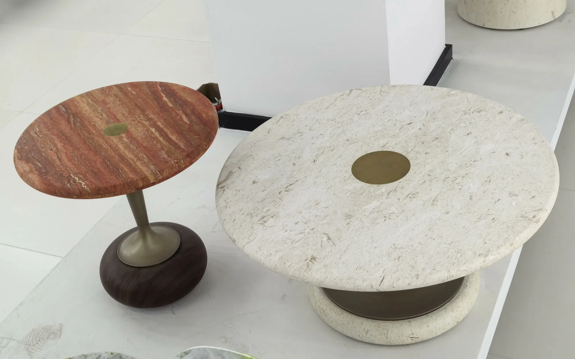 Red and cream travertine coffee tables on a light showroom floor