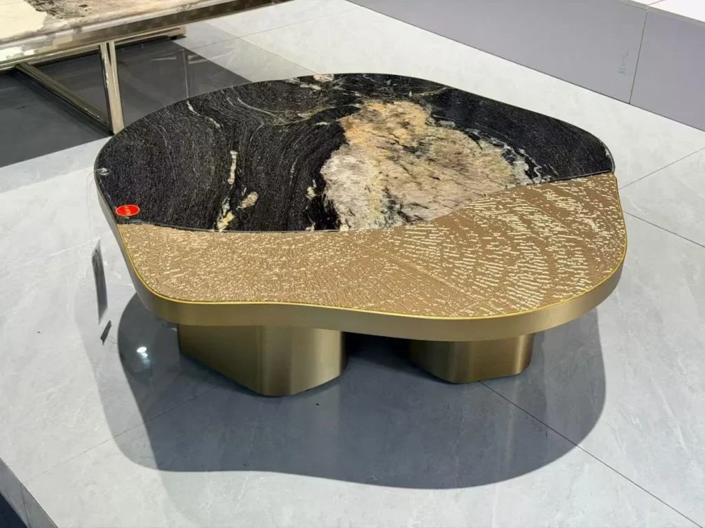 black stone coffee table, with twin supporting bases and bold veining, in a showroom