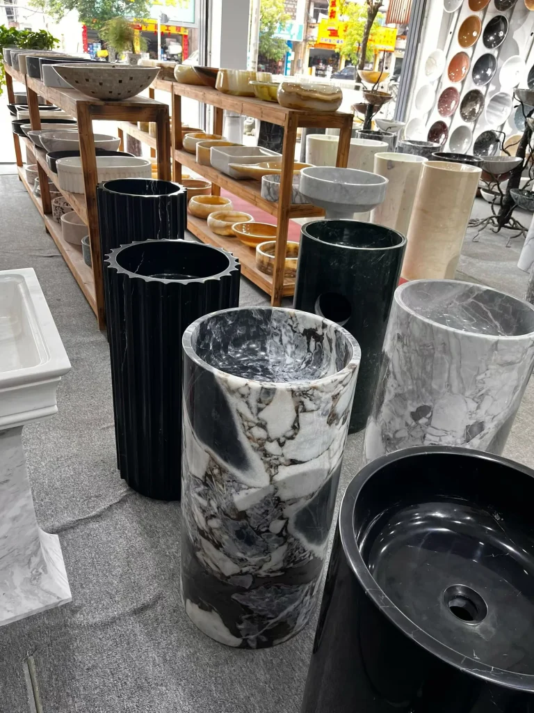 black stone sink, with bold veining and a reflective finish, in a showroom