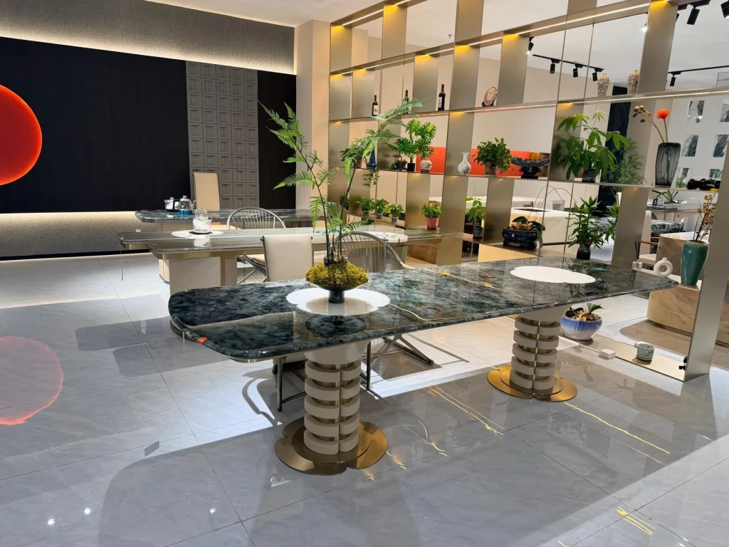 black stone dining table, with twin supporting bases and a crystalline texture, in a showroom