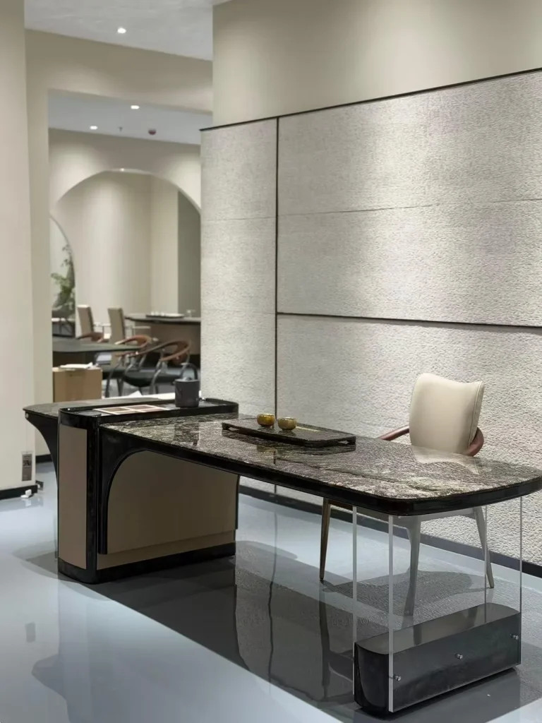black stone desk, with twin supporting bases and a speckled texture, in a showroom