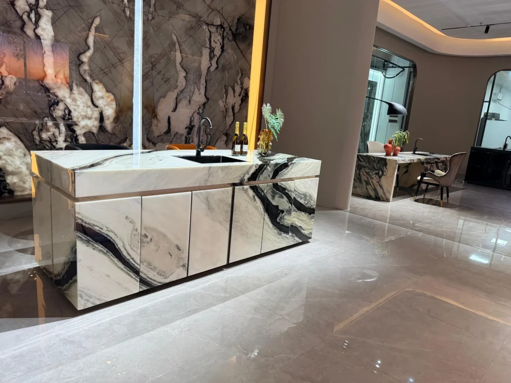 cream-beige stone countertop, with bold veining and a reflective finish, in a showroom