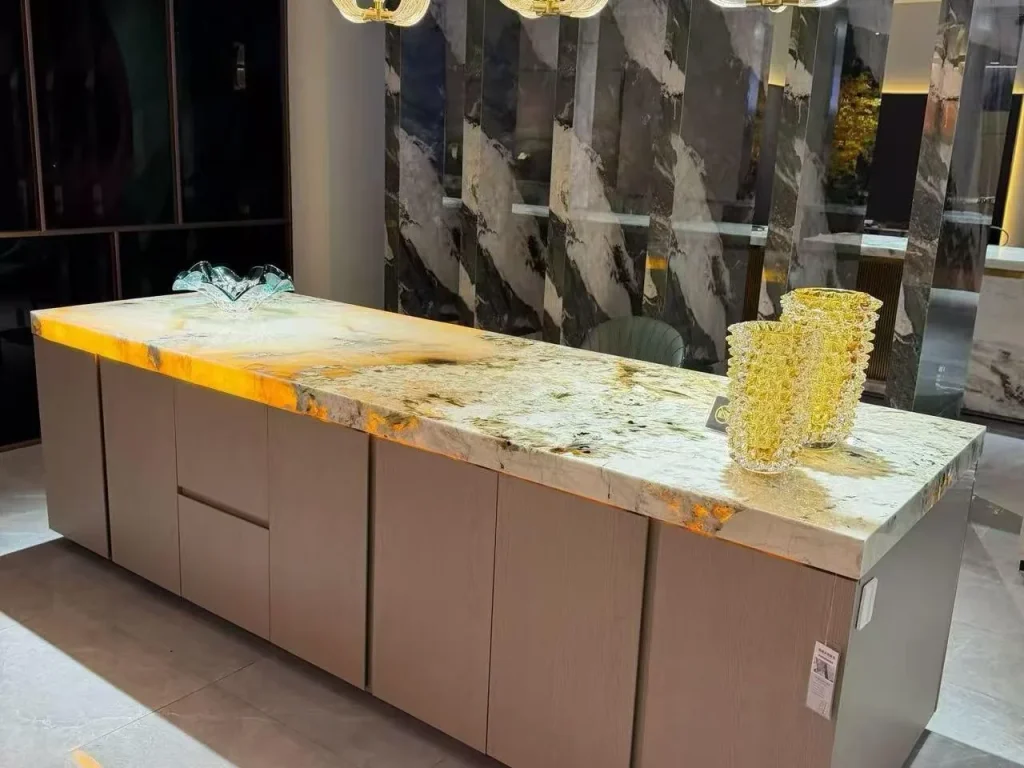 cream-beige stone countertop, with a single-level island and cloudy mottling, in a showroom