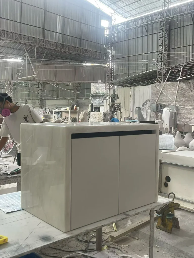 cream-beige stone vanity, with a freestanding cabinet and fine veining, in a workshop