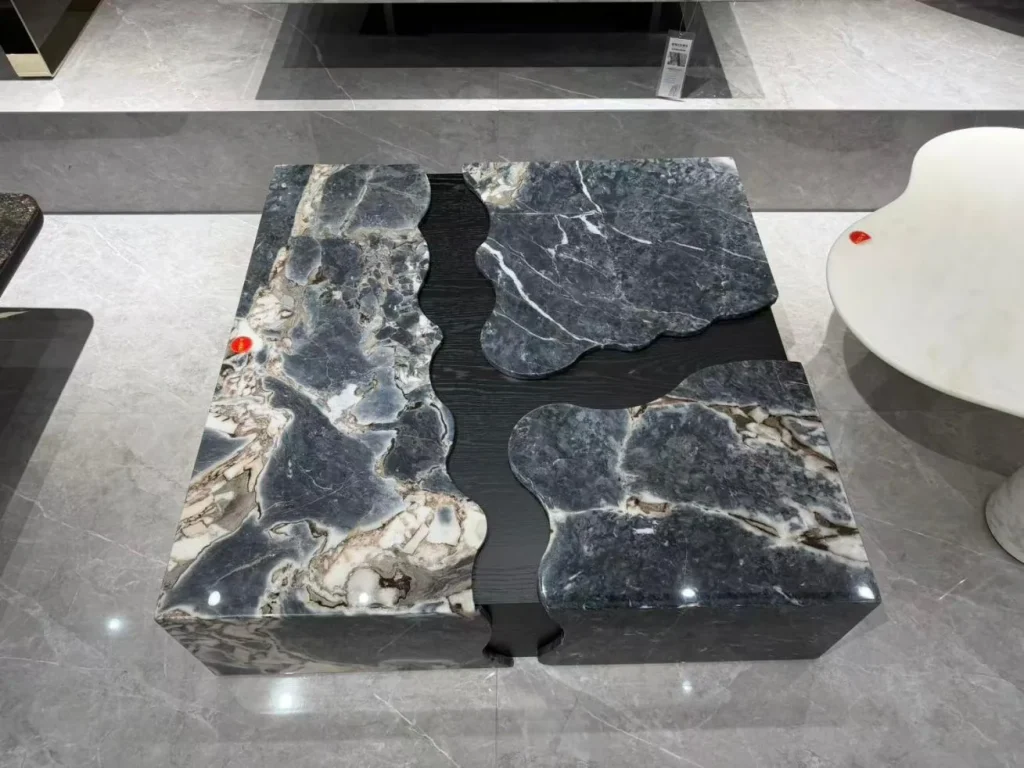 gray stone coffee table, with bold veining and a reflective finish, in a showroom
