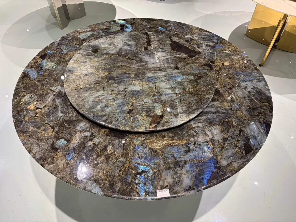 gray stone dining table, with a round top and a crystalline texture, in a showroom