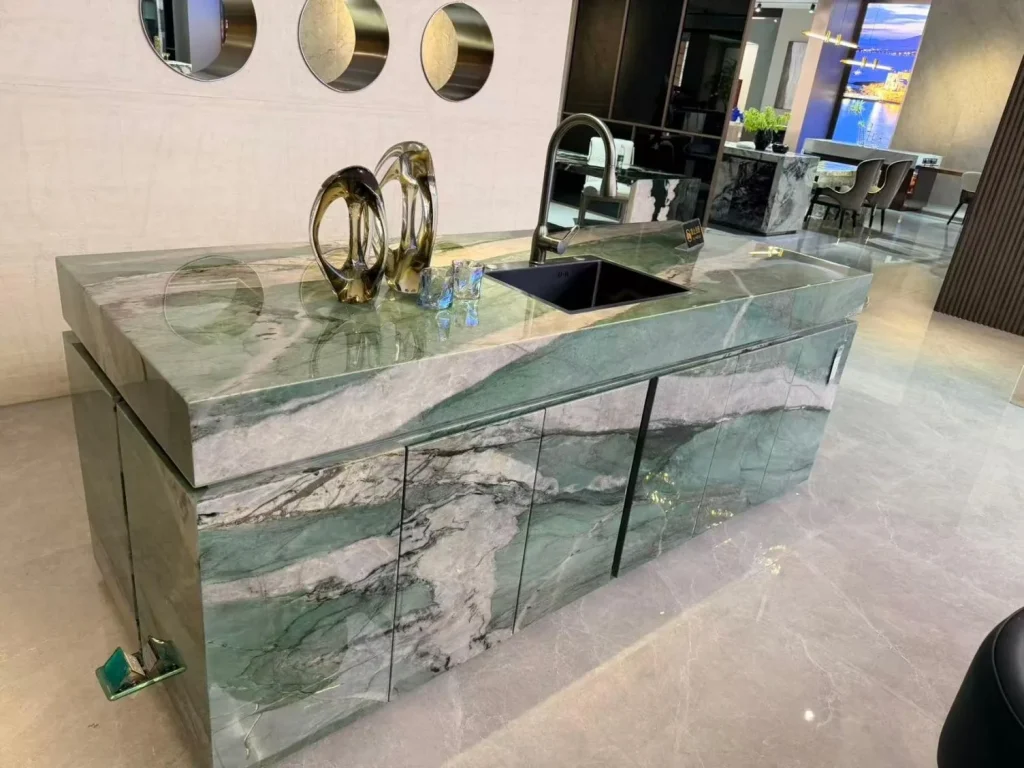 green stone countertop, with bold veining and a reflective finish, in a showroom