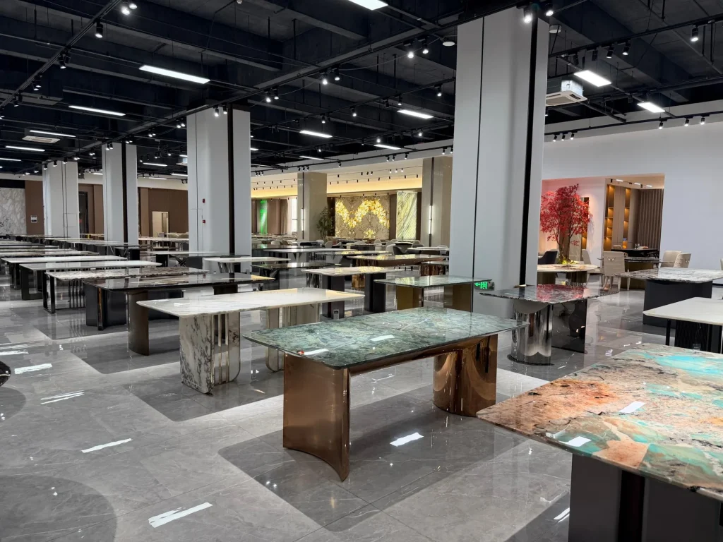 green stone dining table, with twin supporting bases and cloudy mottling, in a showroom