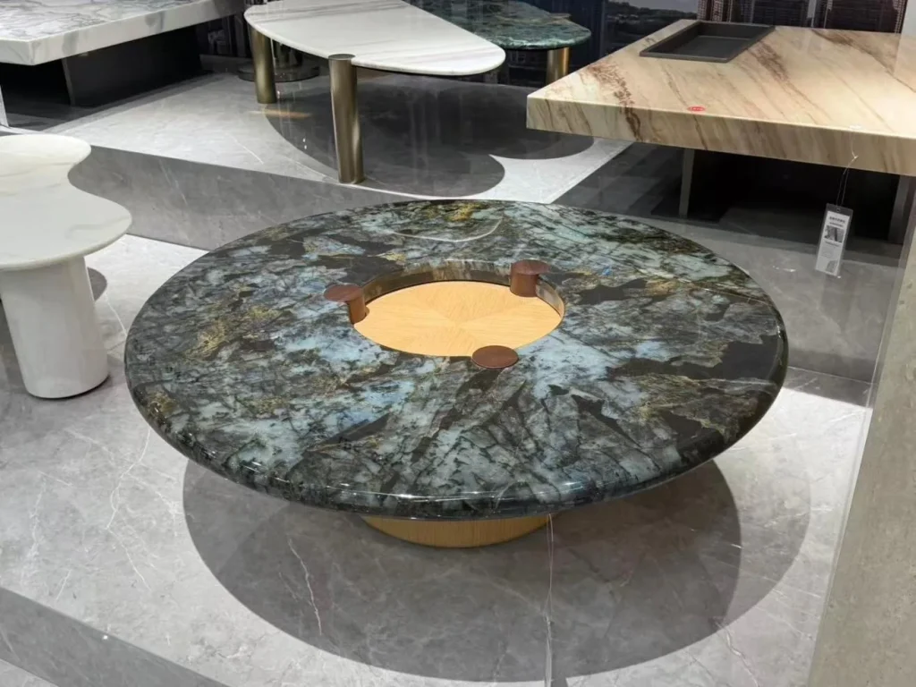 green stone coffee table, with a round top and a crystalline texture, in a showroom